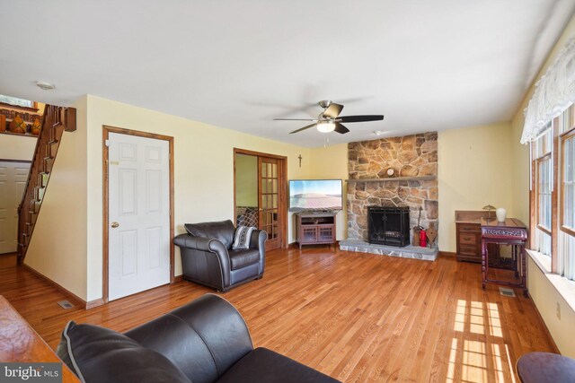 living room with a fireplace, hardwood / wood-style floors, and ceiling fan