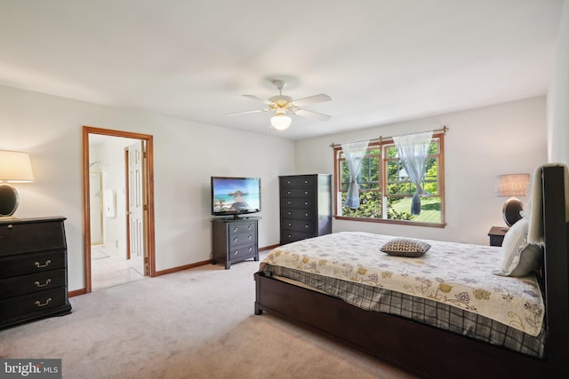 carpeted bedroom with connected bathroom and ceiling fan