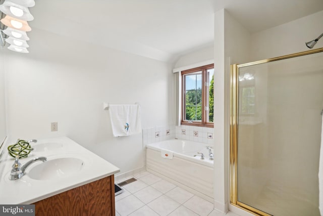 bathroom with vanity, tile patterned flooring, and plus walk in shower