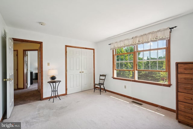 unfurnished bedroom featuring carpet and a closet