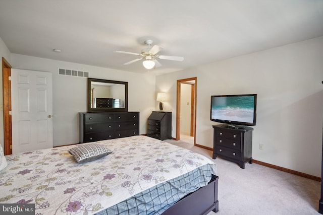 bedroom featuring light colored carpet and ceiling fan