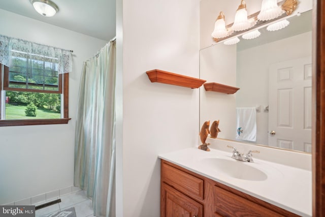 bathroom featuring a shower with shower curtain, vanity, and tile patterned floors