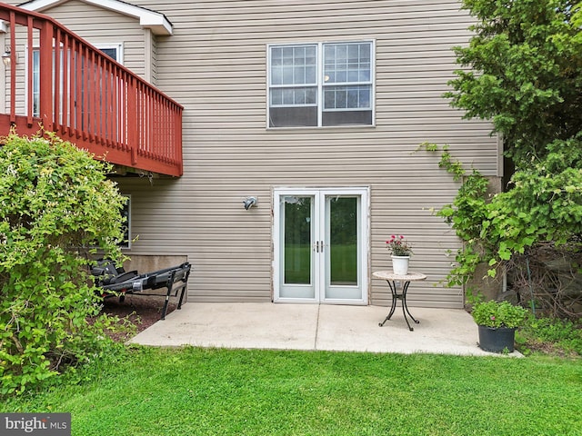 back of house with a lawn, a patio area, and french doors