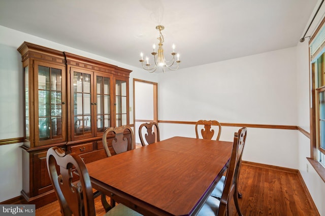 dining space featuring a chandelier and dark hardwood / wood-style floors