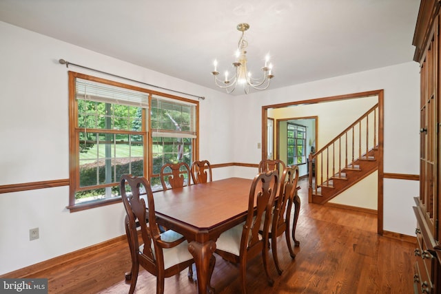 dining room with a healthy amount of sunlight, dark hardwood / wood-style floors, and a notable chandelier