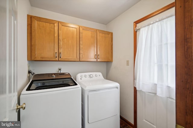 washroom featuring cabinets and separate washer and dryer