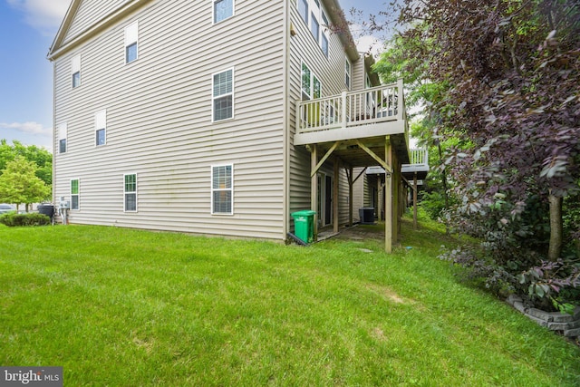 view of side of property featuring a wooden deck and a yard