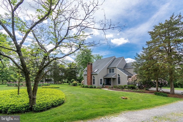 view of side of home featuring a lawn