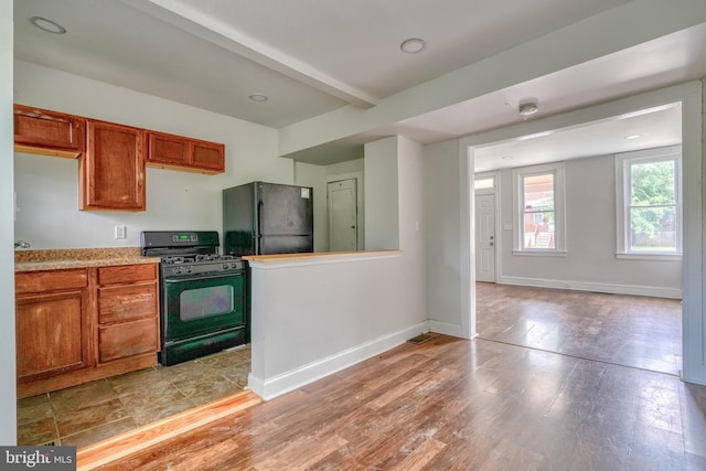 kitchen featuring black appliances and light hardwood / wood-style floors