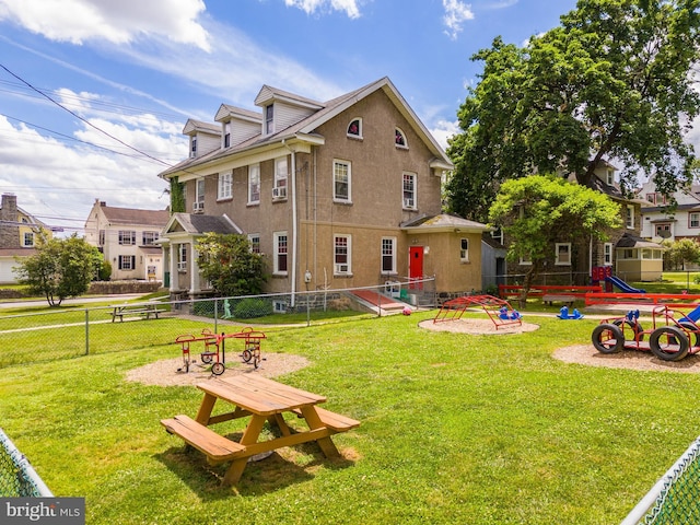 view of property's community with a lawn and a playground