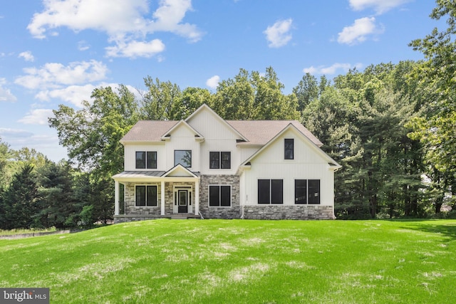 modern farmhouse style home with a porch and a front lawn