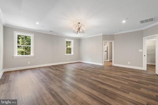 empty room with plenty of natural light, crown molding, and dark wood-type flooring