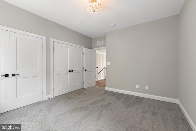 unfurnished bedroom featuring light carpet