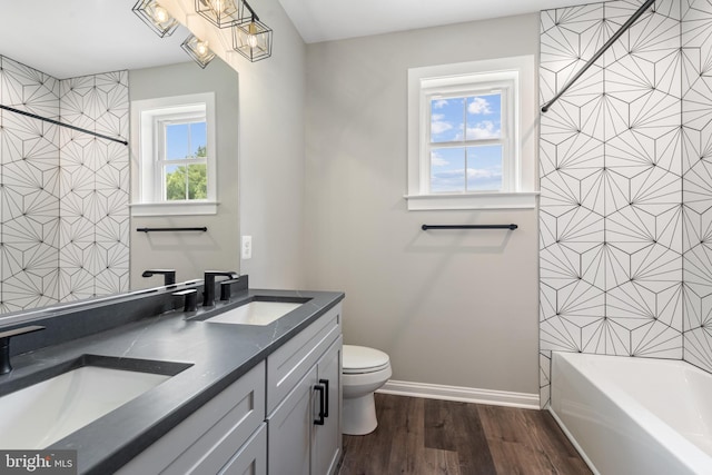 full bathroom featuring wood-type flooring, vanity, toilet, and shower / washtub combination