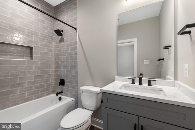 full bathroom featuring vanity, toilet, and tiled shower / bath