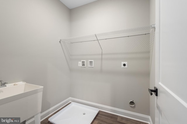 laundry room featuring dark hardwood / wood-style flooring, sink, hookup for a washing machine, and hookup for an electric dryer