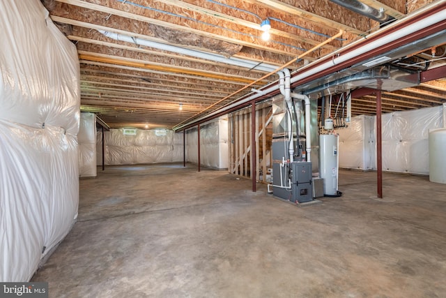 basement featuring heating unit and water heater