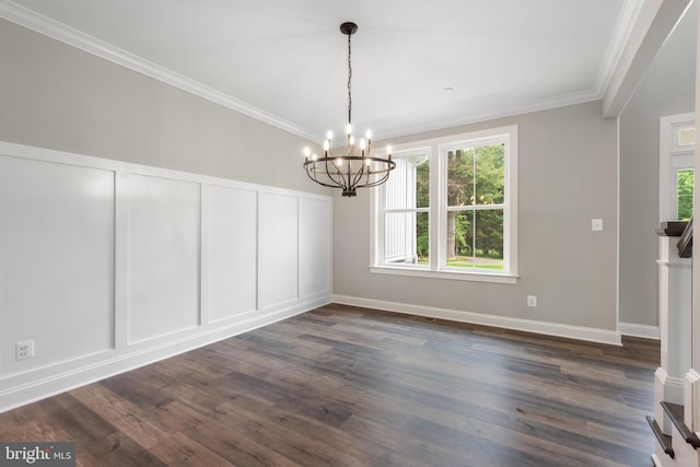 unfurnished dining area with dark hardwood / wood-style flooring, ornamental molding, and an inviting chandelier