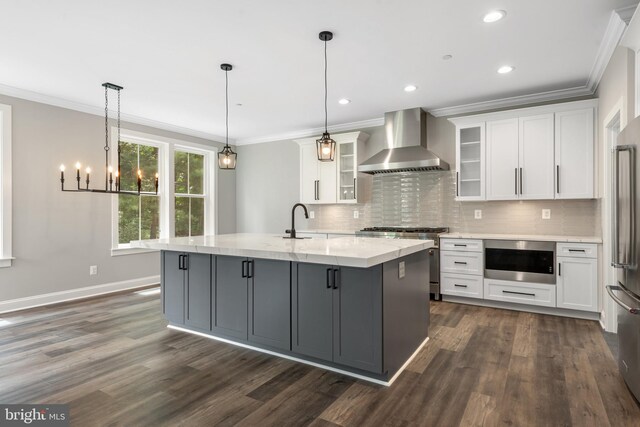 kitchen featuring white cabinets, dark hardwood / wood-style floors, high quality appliances, and wall chimney range hood