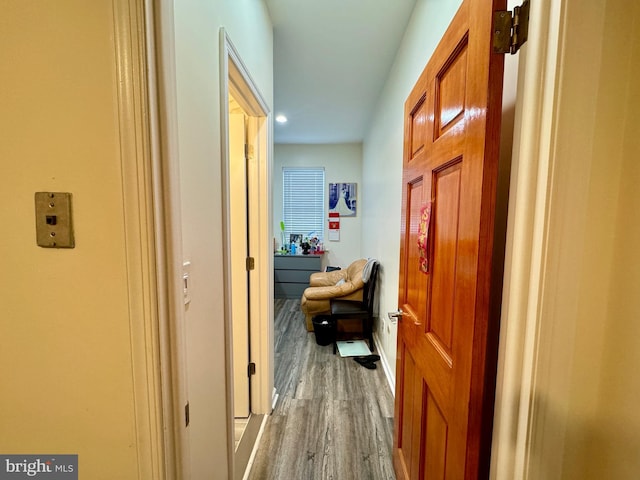 corridor with hardwood / wood-style flooring