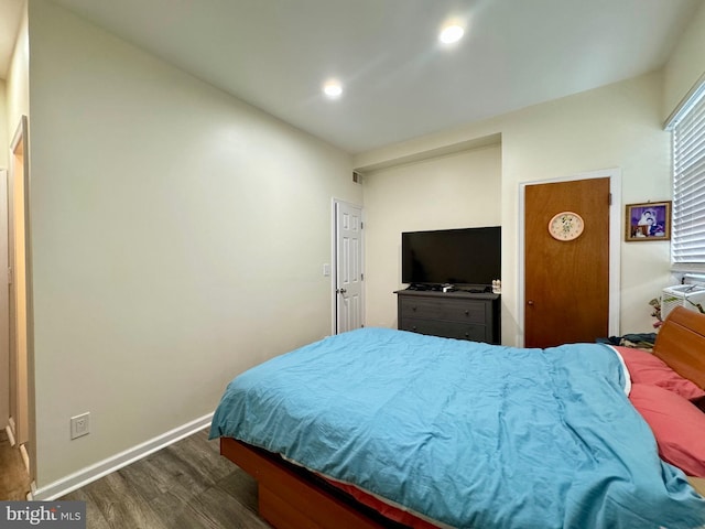 bedroom with dark wood-type flooring