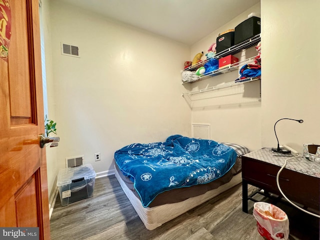 bedroom with hardwood / wood-style floors