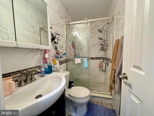 bathroom with backsplash, an enclosed shower, vanity, tile walls, and toilet