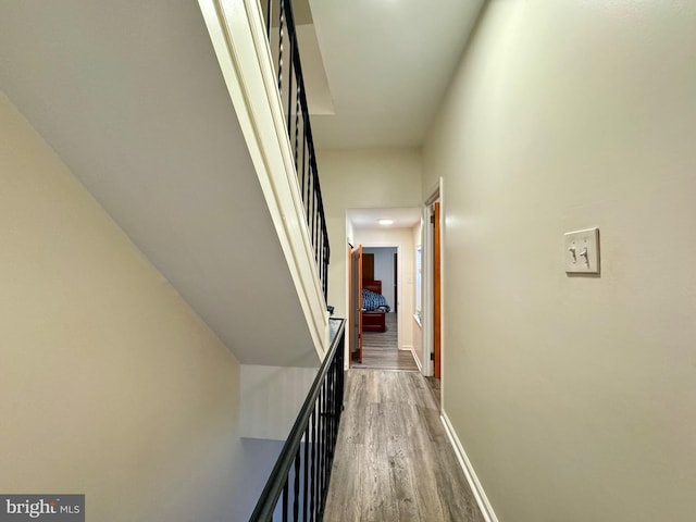 corridor with dark hardwood / wood-style flooring