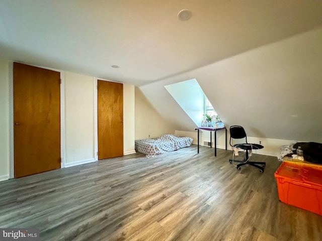 interior space with hardwood / wood-style floors and vaulted ceiling