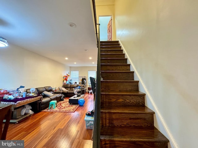 staircase with hardwood / wood-style floors