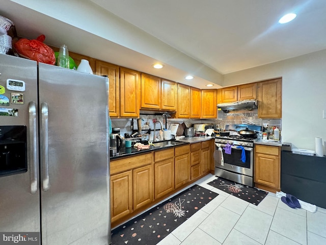 kitchen with backsplash, sink, light tile patterned floors, and stainless steel appliances