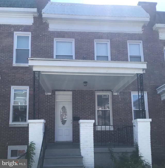 603 Allendale St, Baltimore, MD 21229 - view of property with brick siding and a porch