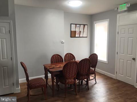 dining space with a healthy amount of sunlight and dark hardwood / wood-style floors