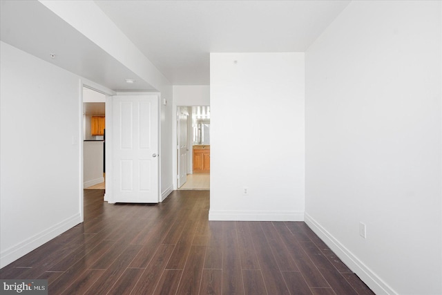 spare room with dark hardwood / wood-style flooring