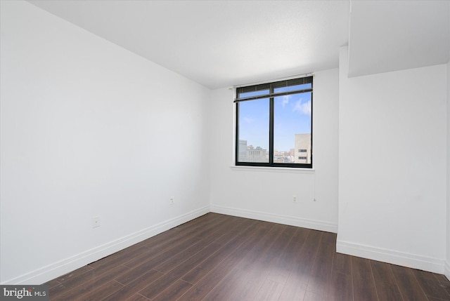 unfurnished room featuring dark hardwood / wood-style flooring