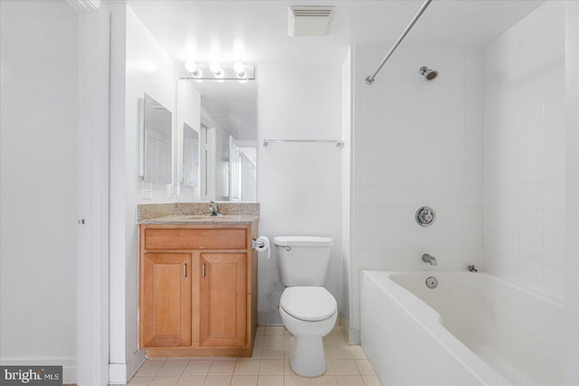 full bathroom with tiled shower / bath, vanity, toilet, and tile patterned flooring