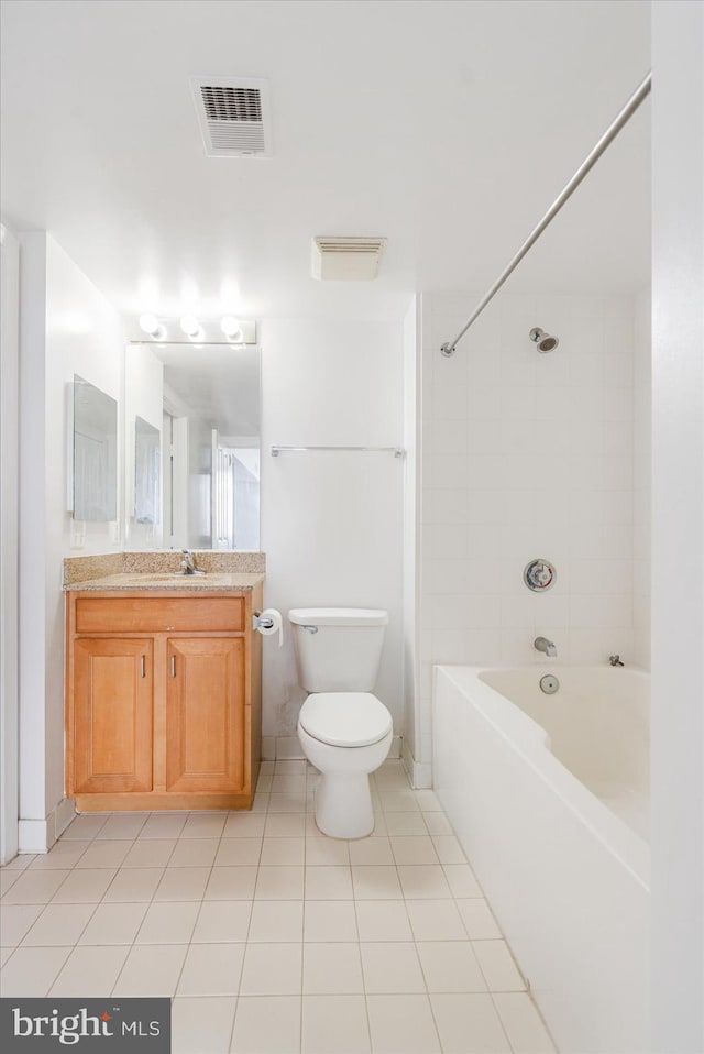 full bathroom with vanity, tiled shower / bath combo, tile patterned floors, and toilet