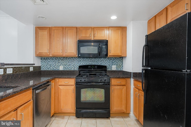 kitchen with light tile patterned flooring, dark stone counters, backsplash, and black appliances