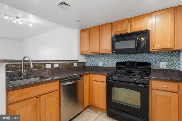 kitchen with light tile patterned floors, backsplash, black appliances, and dark stone counters