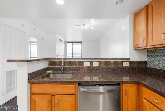 kitchen with stainless steel dishwasher, dark stone counters, sink, and ornamental molding