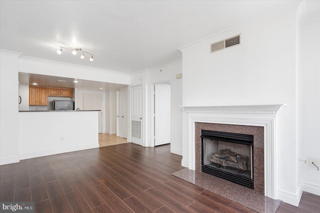 unfurnished living room with dark hardwood / wood-style flooring, a fireplace, and ornamental molding