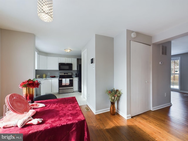 dining area featuring hardwood / wood-style floors and a chandelier