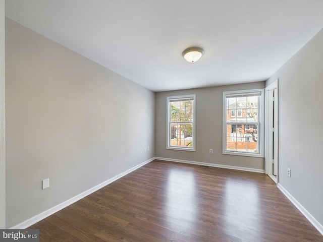 empty room with dark wood-type flooring