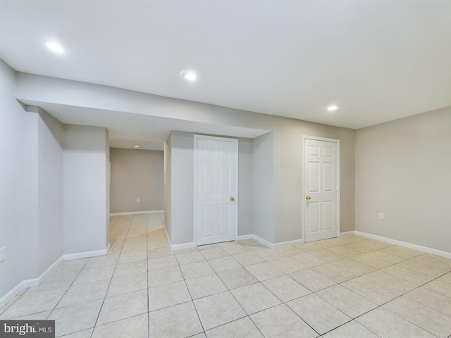 basement featuring light tile patterned floors