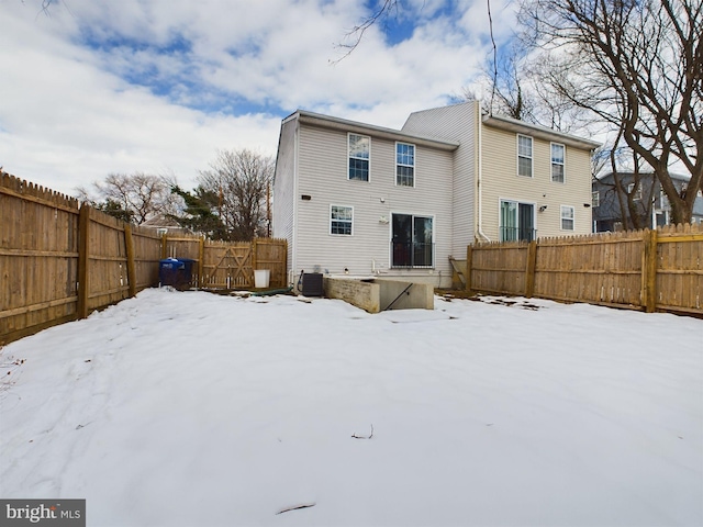 snow covered house with central AC unit