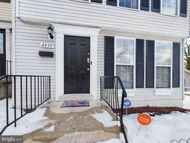 view of snow covered property entrance