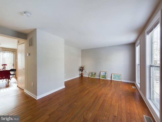 spare room featuring dark wood-type flooring