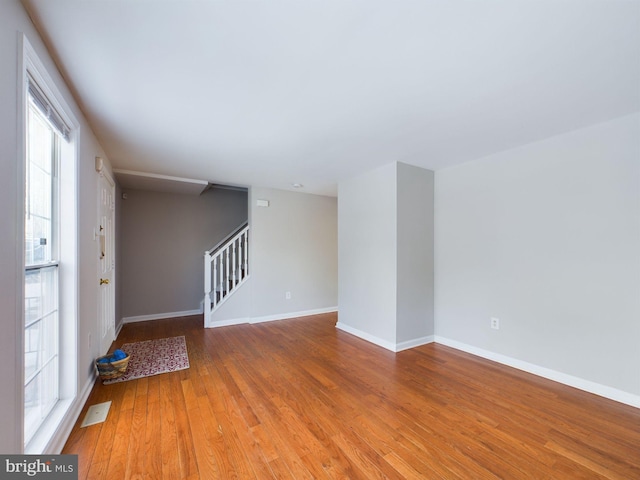 unfurnished room with hardwood / wood-style flooring