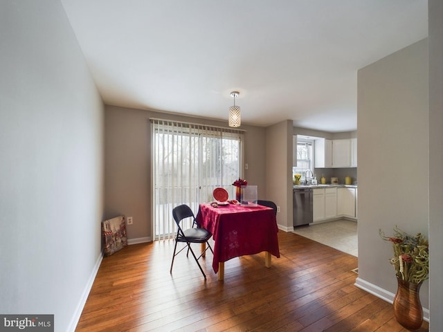 dining room with sink and wood-type flooring