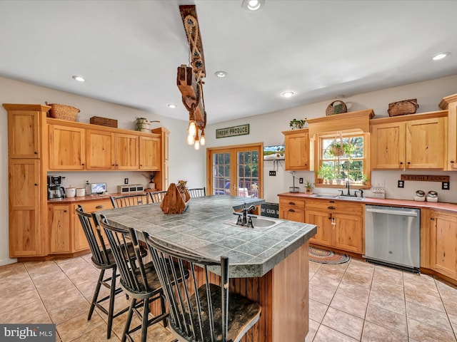 kitchen featuring a center island, french doors, stainless steel dishwasher, light tile patterned floors, and a kitchen bar